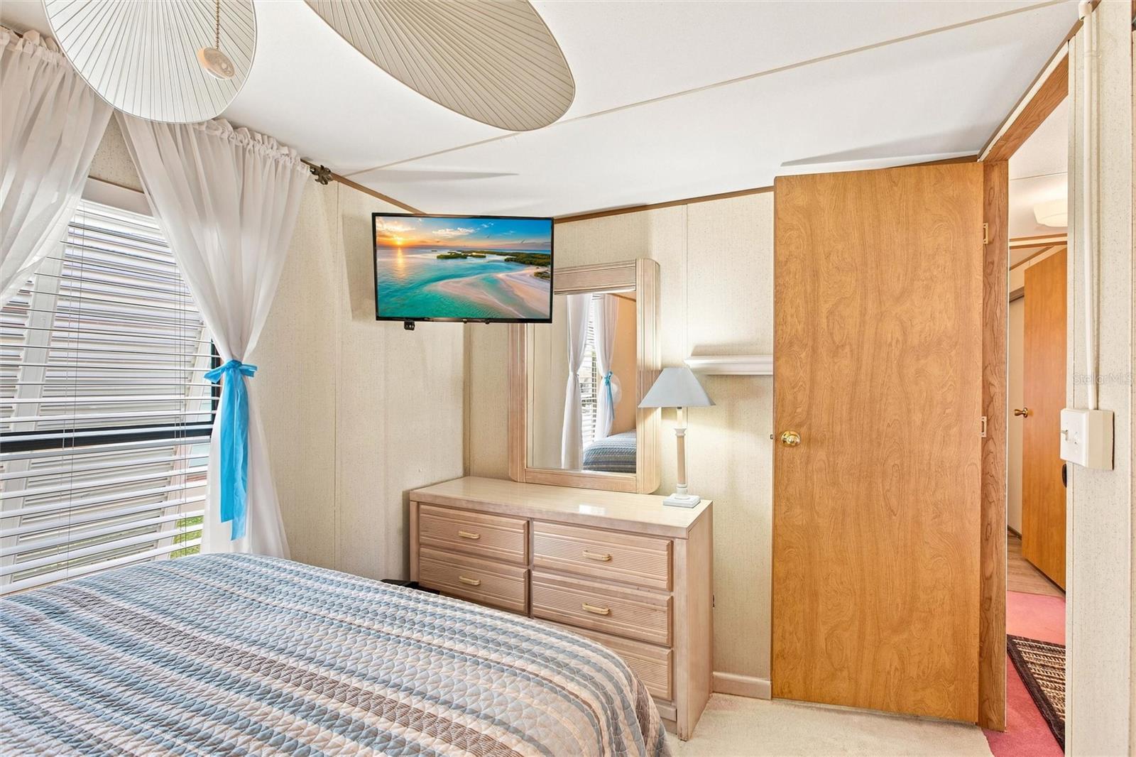 bedroom with dresser and television