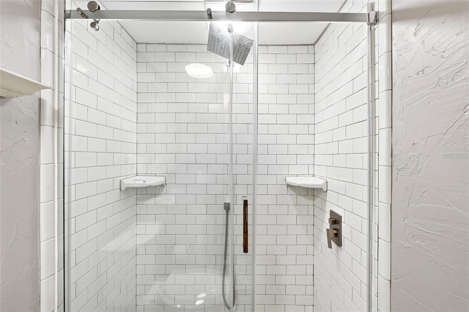 updated walk-in shower and glass sliding doors