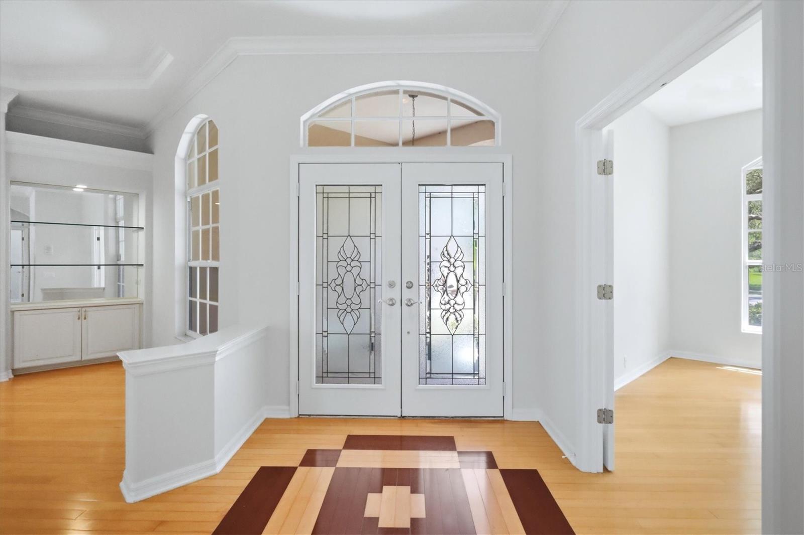 Front door Foyer entry with dining to left and den/office with 1/2 bath to the right
