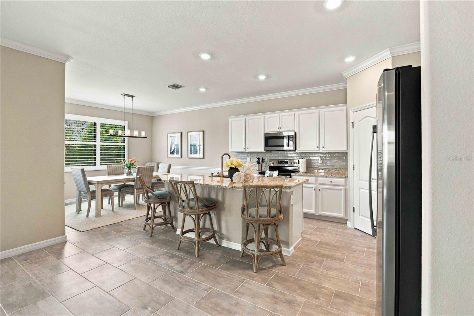 The center island is set for 3 in this home, but easily will seat another 4th chair