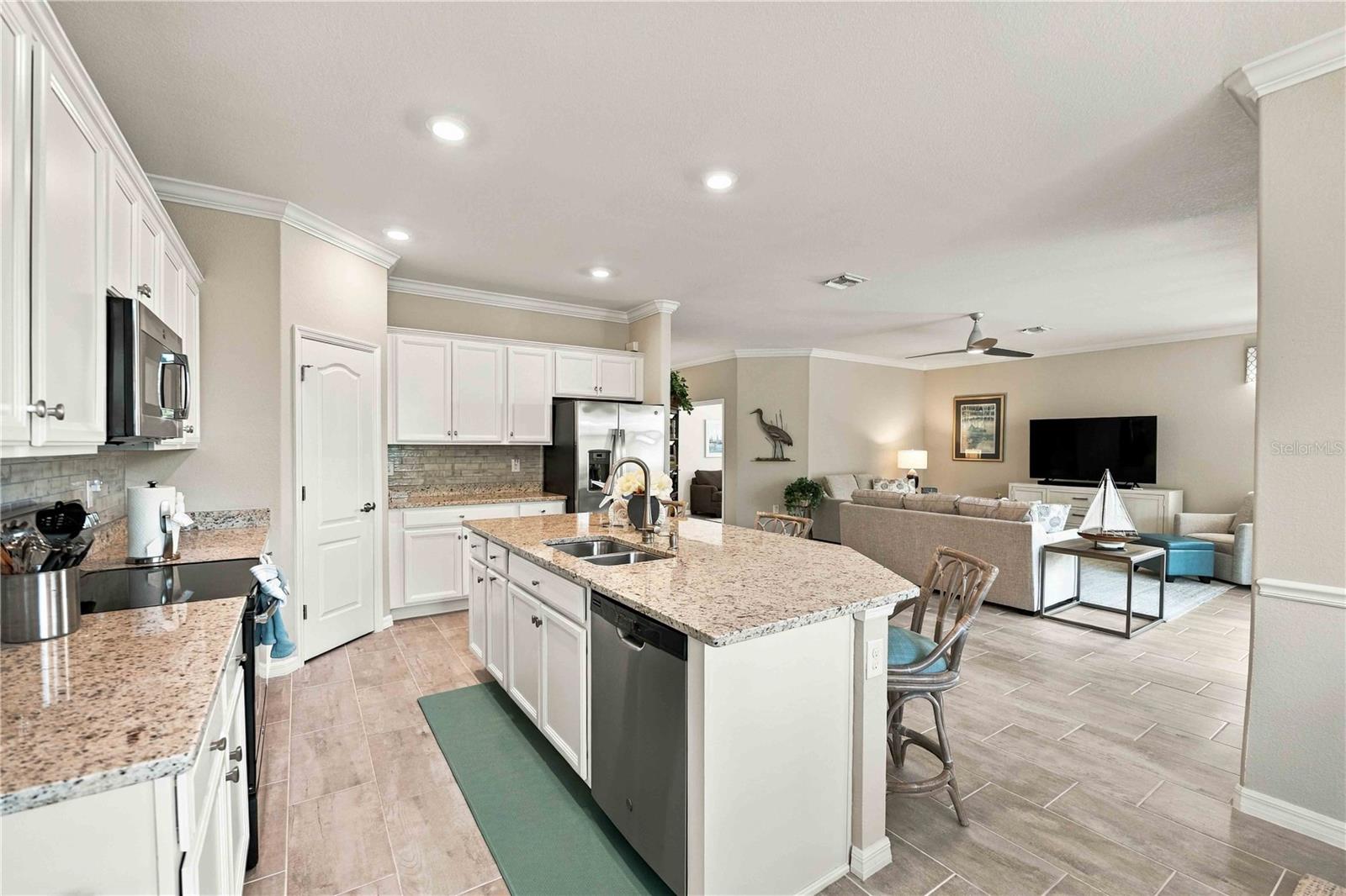 The center island is set for 3 in this home, but easily will seat another 4th chair